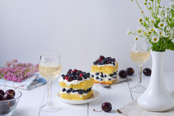 Sponge cake with fresh berries and curd cream for lovers. Summer romantic dessert. Surprise for the beloved.
