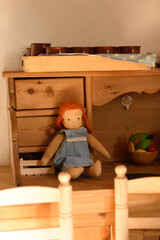 Walrdorf pedagogy doll in a wooden kitchen for children.