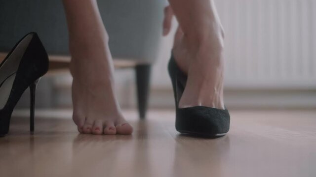 Close Up Of Woman Putting On High Heels