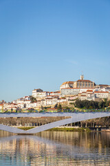 historic Coimbra cityscape with university at top of the hill in the evening, Portugal