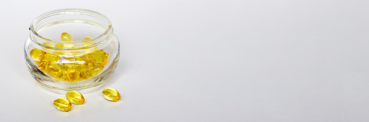 Glass jar of yellow medical pills on white background. Medical concept.