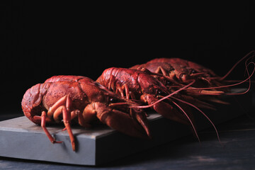 Red boiled crayfish on a wooden board close-up. Great beer snack.