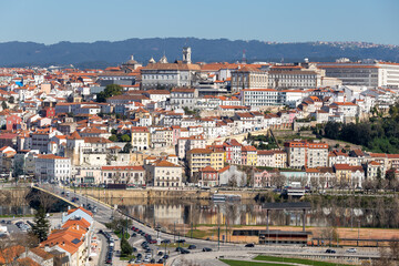 Fototapeta na wymiar historic Coimbra cityscape with university at top of the hill in the evening, Portugal