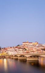 historic Coimbra cityscape with university at top of the hill in the evening, Portugal