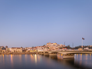 historic Coimbra cityscape with university at top of the hill in the evening, Portugal