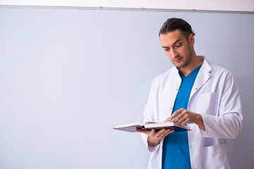 Young male doctor in presentation concept
