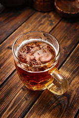 Top view over a beer mug on dark wooden table