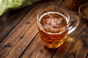 Mug of beer on dark rustic background