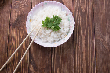 boiled rice with soy sauce close-up on a light background