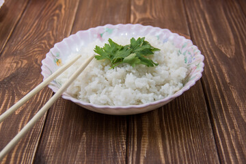 boiled rice with soy sauce close-up on a light background