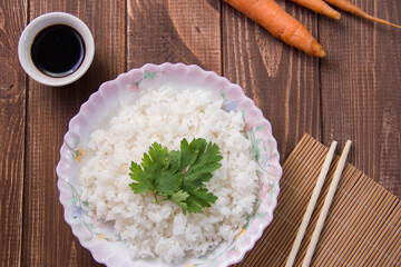boiled rice with soy sauce close-up on a light background