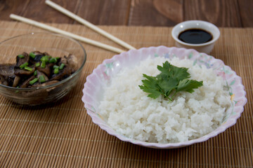 Rice with soy sauce and boiled vegetables close-up on a decorative background. Rice Dish. Fried mushrooms. Healthy eating Vegetarian food. Vegetarian dish