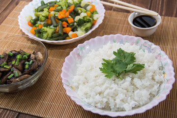 Rice with soy sauce and boiled vegetables close-up on a decorative background. Rice Dish. Fried mushrooms. Healthy eating Vegetarian food. Vegetarian dish
