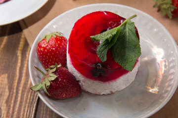 dessert with strawberries close-up on a decorative background. Strawberry jelly. 
Delicate Strawberry Cheesecake On A White Plate