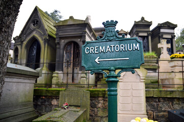 A direction sign in a cemetery, which gives the direction of a crematorium for a funeral cremation...