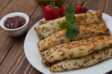 fried pancakes and strawberries closeup on a wooden table. Dessert. Healthy breakfast. Proper nutrition