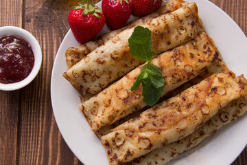 fried pancakes and strawberries closeup on a wooden table. Dessert. Healthy breakfast. Proper nutrition