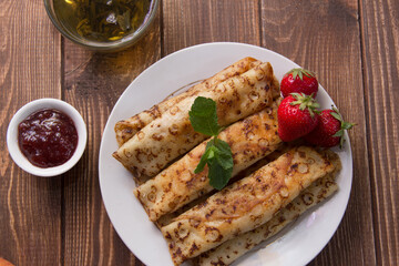 fried pancakes and strawberries closeup on a wooden table. Dessert. Healthy breakfast. Proper nutrition