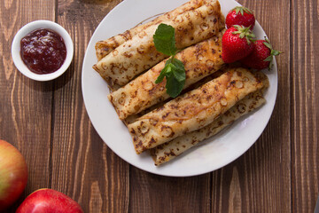 fried pancakes and strawberries closeup on a wooden table. Dessert. Healthy breakfast. Proper nutrition