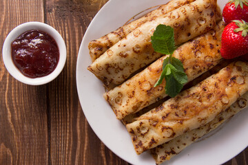fried pancakes and strawberries closeup on a wooden table. Dessert. Healthy breakfast. Proper nutrition