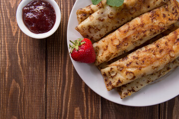 fried pancakes and strawberries closeup on a wooden table. Dessert. Healthy breakfast. Proper nutrition
