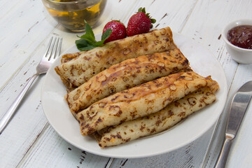 fried pancakes and strawberries closeup on a wooden table. Dessert. Healthy breakfast. Proper nutrition
