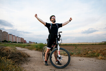 cyclist raising his arms in a sign of victory