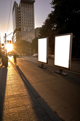 Blank advertising mockup in the street . Poster billboard on the city at night background