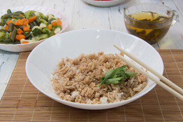 Rice with soy sauce and boiled vegetables close-up on a decorative background. Rice Dish. Fried mushrooms. Healthy eating Vegetarian food. Vegetarian dish