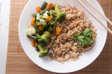 Rice with soy sauce and boiled vegetables close-up on a decorative background. Rice Dish. Fried mushrooms. Healthy eating Vegetarian food. Vegetarian dish