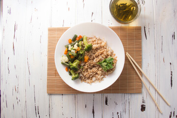 Rice with soy sauce and boiled vegetables close-up on a decorative background. Rice Dish. Fried mushrooms. Healthy eating Vegetarian food. Vegetarian dish
