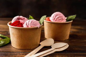 Close up of strawberry ice cream in eco craft paper cups