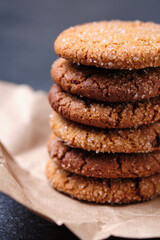 Tower of oatmeal cookies with honey. Dessert on brown paper, on the table close-up.