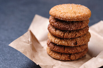 Tower of oatmeal cookies with honey. Dessert on brown paper, on the table close-up.