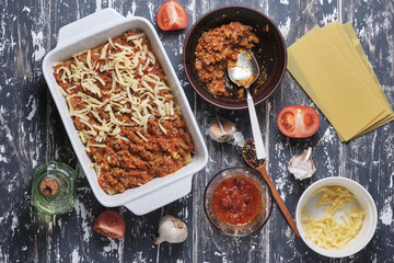 The process of preparing Italian rustic lasagna. Stages of cooking. Ingredients and place for signature. Top view.