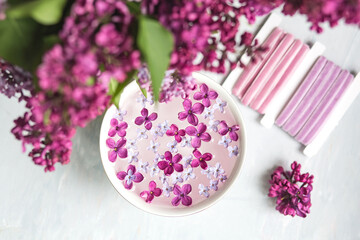Five-pointed lilac flower among lilac flowers in a cup with water. Lilac branch with a flower with 5 petals.