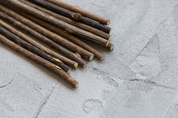 Natural catnip sticks for cat molar cleaning and relaxing, chewing snack on gray background, copy...