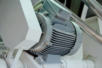 Industrial electric motor and pipes. grain mill
