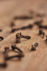 Carnation buds on a wooden board. Macro shot of spices.