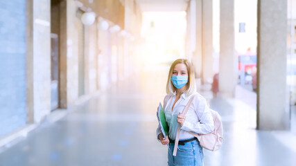 Female student or school girl in mask with backpack and exercise books over urban scene. Back to school. Studying after quarantine