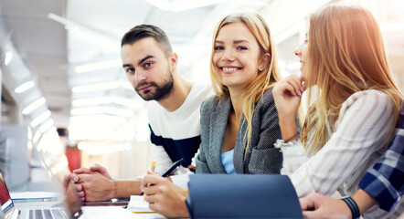 Smiling handsome young international students resting after lesson 
