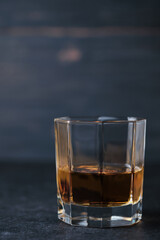Glass of whiskey on a wooden table in a bar. Bar counter with an alcoholic drink.