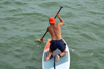 Young man paddle boarding on Biscayne Bay near Miami Beach,F.orida.