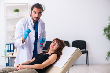 Young woman visiting male doctor dermatologist