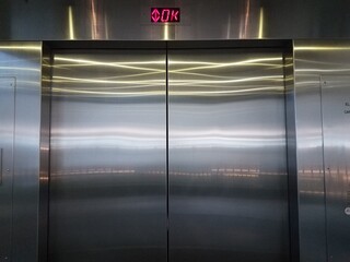 inside an elevator with shiny metal doors