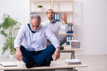 Two male employees working in the office