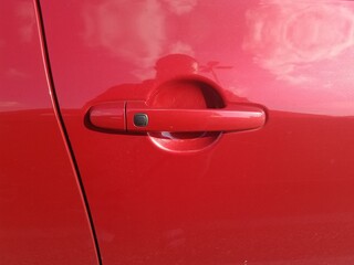 door handle of red automobile
