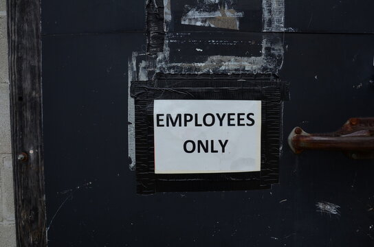 Employees Only Sign Taped On Closed Door