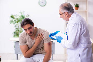 Young face injured man visiting experienced male doctor traumato
