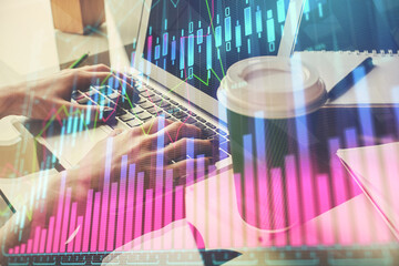 Double exposure of woman hands typing on computer and forex chart hologram drawing. Stock market invest concept.